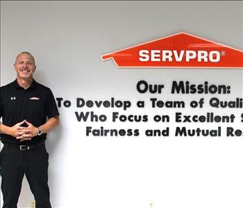 director of training in front of our mission statement