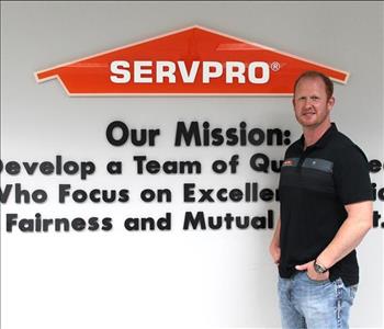 COO standing in front of our mission statement