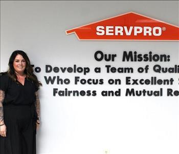 AR standing in front of our mission statement