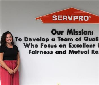 JFC standing in front of our mission statement