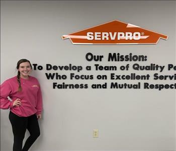 woman in front of mission statement