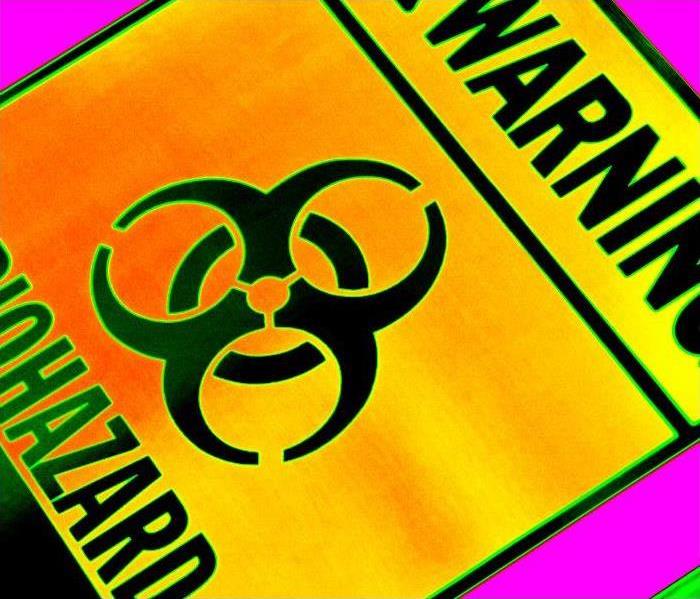 biohazard symbol on yellow-orange square with black stripes horizontal and warning on the top, biohazard on bottom.