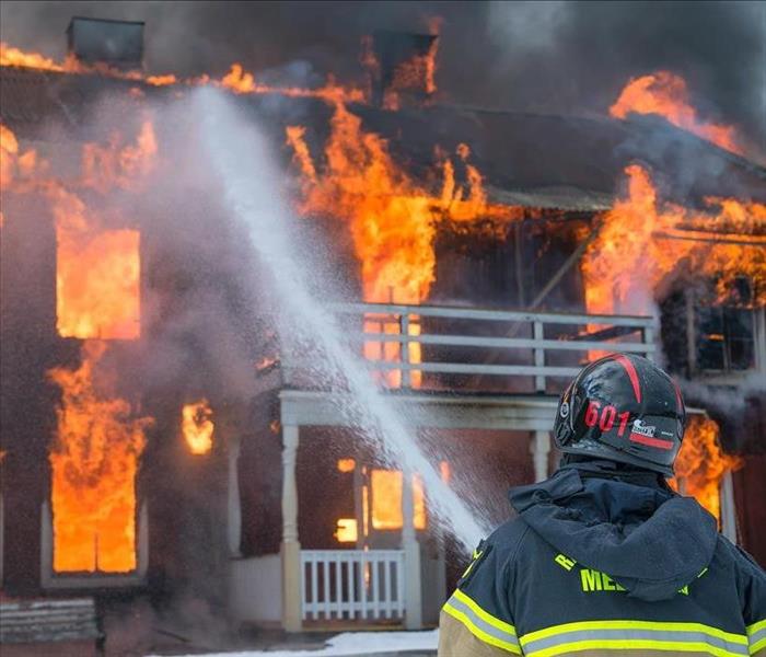 Firemen put out a house fire